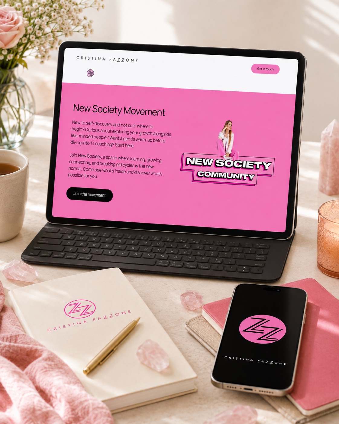 Cristina Fazzone New Society Movement webpage on an iPad with branded items in the background
